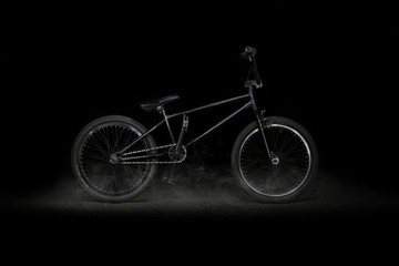 Fototapeta na wymiar BMX bike on black background with smoke