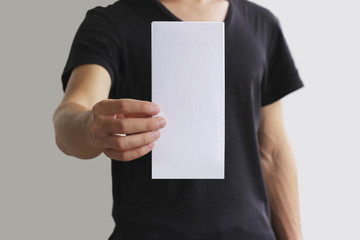 Man showing blank white flyer brochure booklet. Leaflet presentation. Pamphlet hold hands. Man show...