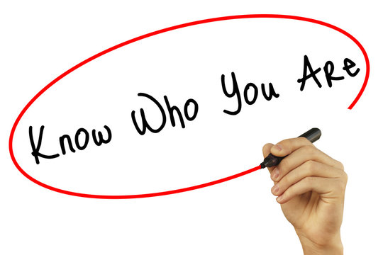 Man Hand writing Know Who You Are with black marker on visual screen. Isolated on background. Business, technology, internet concept. Stock Photo