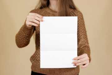 Girl showing blank black flyer brochure. Detailed booklet. Leaflet presentation. Pamphlet hold...