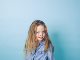 young girl in front of blue background