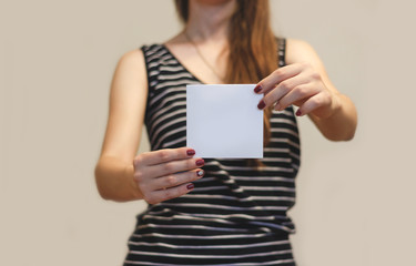 Girl showing blank white square flyer brochure booklet. Leaflet presentation. Pamphlet hold hands....