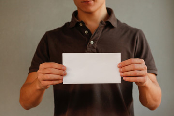 Man showing horizontal blank white flyer brochure booklet. Leaflet presentation. Pamphlet hold hands. Man show clear offset paper. Sheet template. Booklet design sheet display read first person