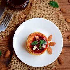 Tasty homemade cottage cheese pancakes. Easy cottage cheese pancakes with berry jam and nuts. Top view