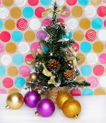 artificial Christmas fir tree with balls and pine cone