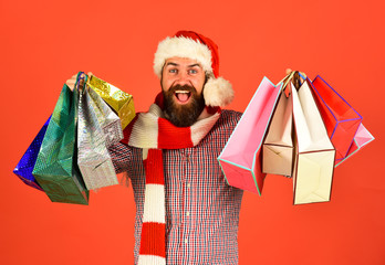 Guy or hipster shopper in red hat with shopping bags