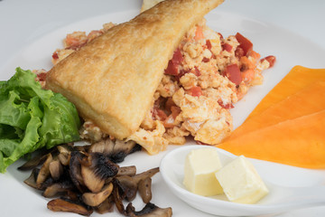 Breakfast with scrambled eggs and tomatoes