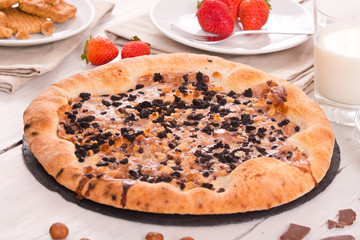 Sweet chocolate pizza with cookies. 