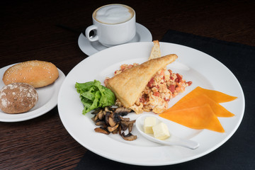 Breakfast with scrambled eggs and tomatoes