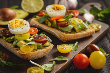 Bruschetta with avocado, egg and tomatoes.