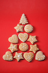 Christmas homemade gingerbread cookies on red background. Top view.
