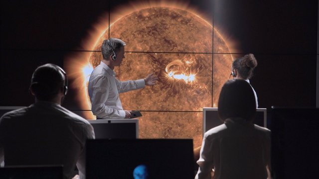 Multiracial team of scientists investigating and analyzing solar eclipse and solar activity. Elements of this image furnished by NASA.