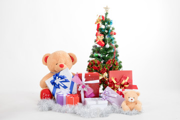 Bear doll with boxs gifts and christmas tree on white background in christmas festival