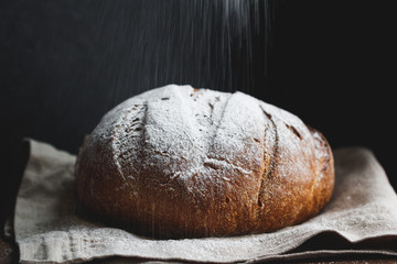 The bread is being sprinkled with flour