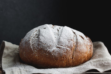 Close-up of fresh rye bread on a black background.