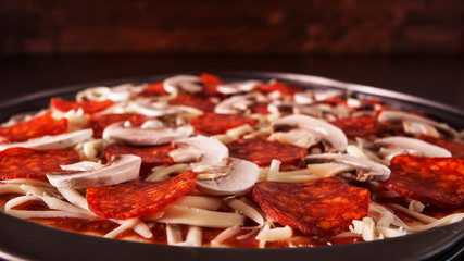 Homemade fresh pizza ready to be baked - closeup