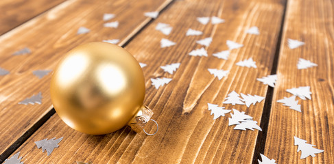 gold christmas ball on a wooden background