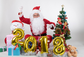 Santa claus with gifts boxs and christmas tree on white background in new year 2018 concept