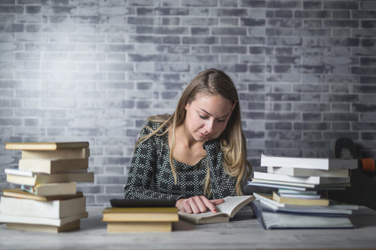 Young woman reading and studying at home
