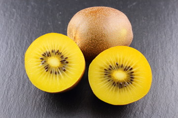 fresh yellow kiwi fruits on a slate plate
