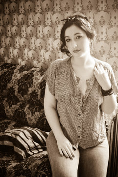 Young Lady with pale skin plus size in vintage pin up retro style at cozy home. Pretty casual retro style 40-5 years for xl size woman