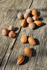 almonds and hazelnuts on a wooden background