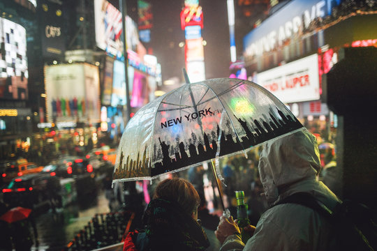 New York Times Square people with rain umbrellas