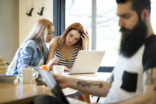 Women working together on laptop computer