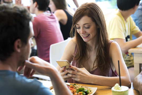 Woman using smartphone in restaurant