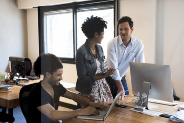 Colleagues chatting in office