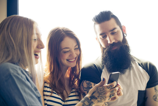 Friends looking at smartphone together