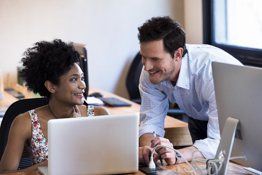 Colleagues chatting in office