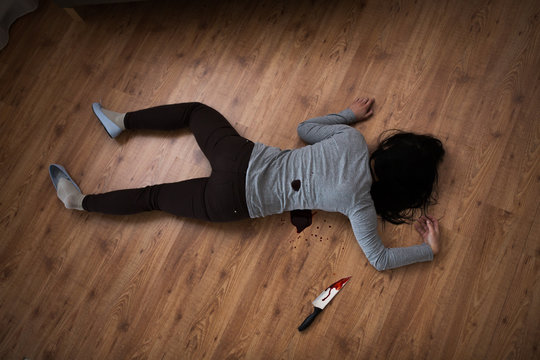 Dead Woman Body Lying On Floor At Crime Scene