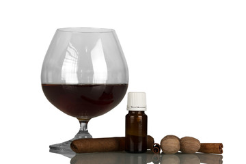 Glass with alcohol and cigar, liquid for smoking with aroma of spices, isolated on white