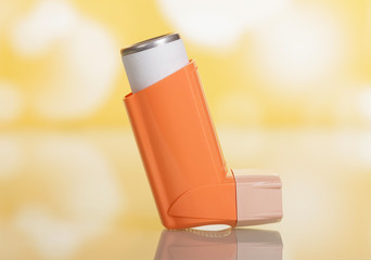 Portable pocket inhaler for asthmatics, on yellow - obrazy, fototapety, plakaty