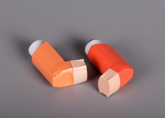 Two pocket inhalers for breathing on gray