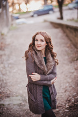 Pippin cover lady with brunette hairs deep blue eyes pout pink lips wearing cozy warm jacket sweater with fur pose sit for calendar journal title scene in ancient central park city