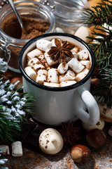 cup of hot chocolate with marshmallows and sweets on wooden table, vertical closeup
