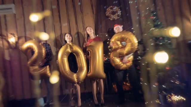 Friends celebrate 2018 year with balloons in this number shape.