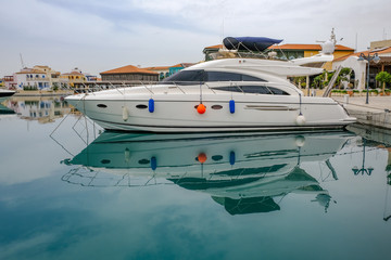 Luxury motorboat moored in Limassol Marina with reflection