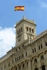 Fototapeta na wymiar Spanish National Flag on top of the Ministry of Defence of Spain, Madrid, Spain