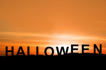 silhouette sunset view with words halloween on the mountain