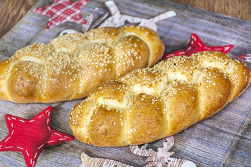 Festive bread plait  with red christmas decorations 