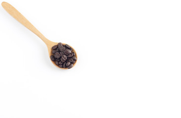Coffee seeds in wooden spoon on white background