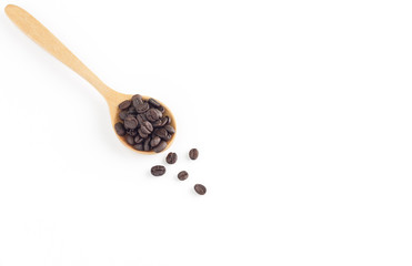 Coffee seeds in wooden spoon on white background