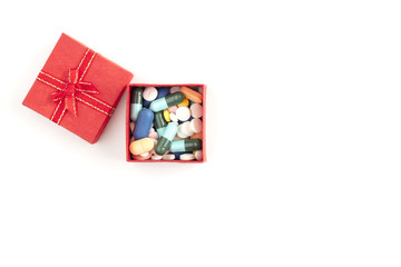 Pharmaceutical in red gift box on white background