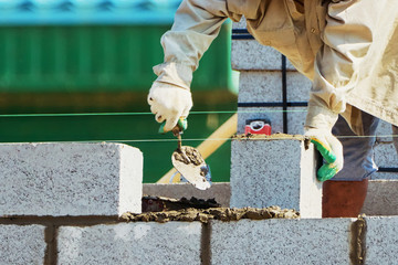 Mason on laying bricks