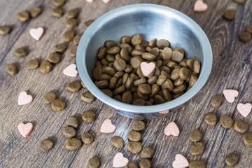 dry dog food in bowl and vitamins for healthy  dog treats 
