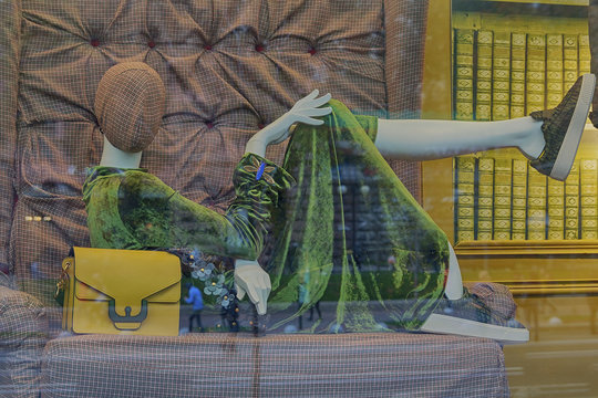 Female Mannequin In The Shop Window. City