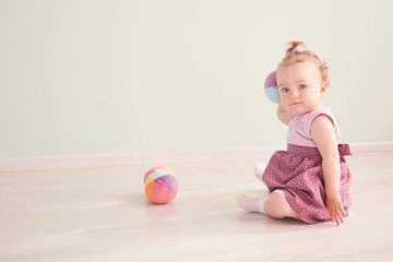 little child is playing with toys in the studio